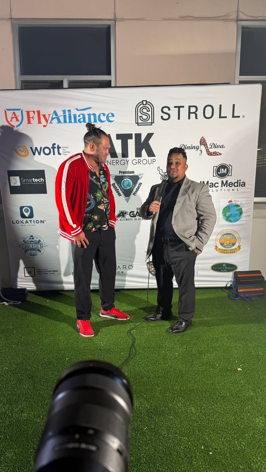On-camera interview on a red carpet step-and-repeat